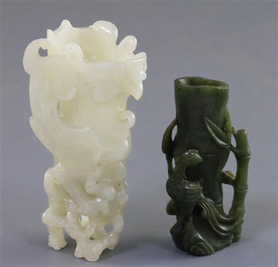 A Chinese archaistic white jade rhyton and a spinach green jade vase, 18th/19th century, H. 11cm and 8.5cm